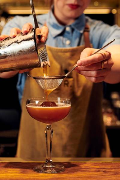 Strain martini espresso into glass
