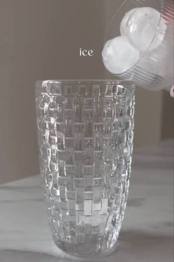 add ice cubes in glass cocktail shaker