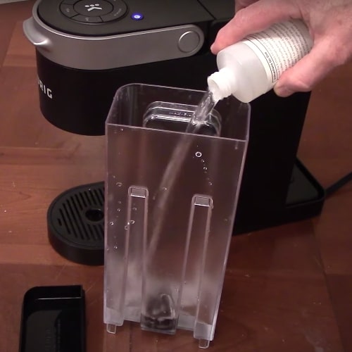 descaling solution and water into Keurig slim water reservoir