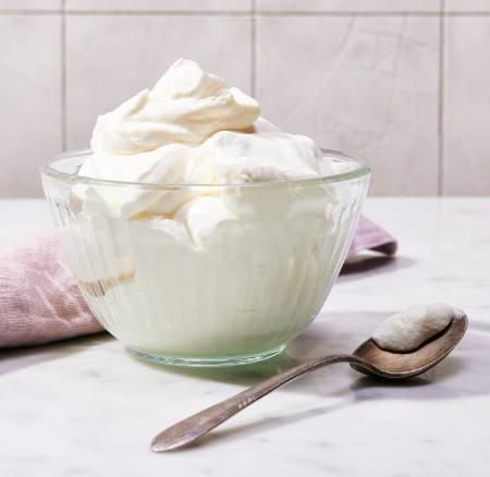 whipping cream in glass bowl