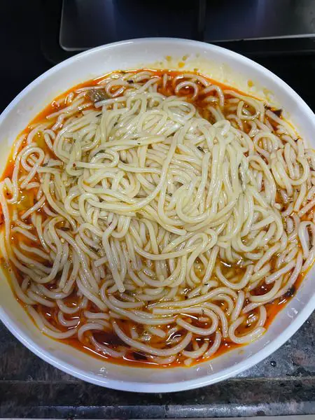 Step 7 Pour mala sauce over the noodles